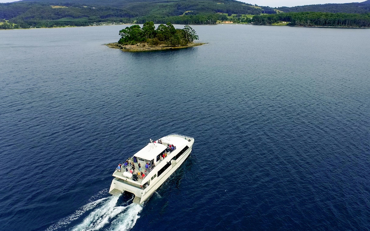 Cruise boat near small island at Port Arthur Historic Site, Tasmania.