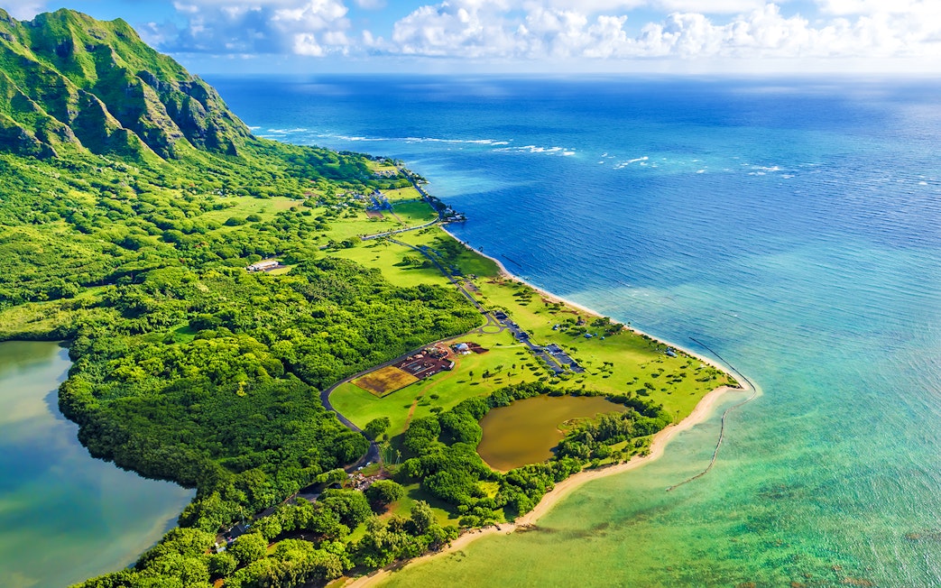 Aerial view of Kualoa Point and lush greenery at Kaneohe Bay, Hawaii.