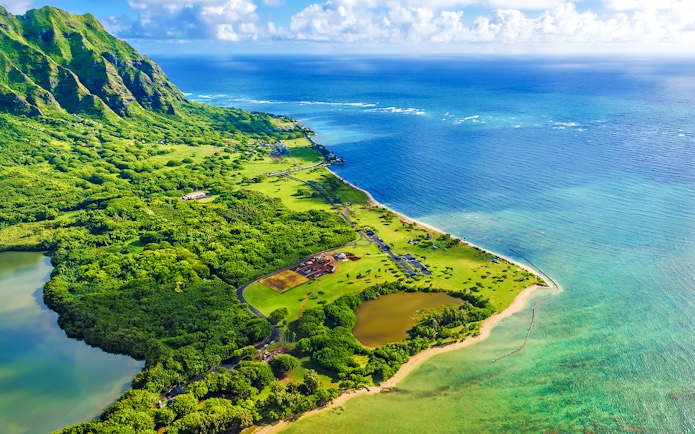 Aerial view of Kualoa Point and lush greenery at Kaneohe Bay, Hawaii.