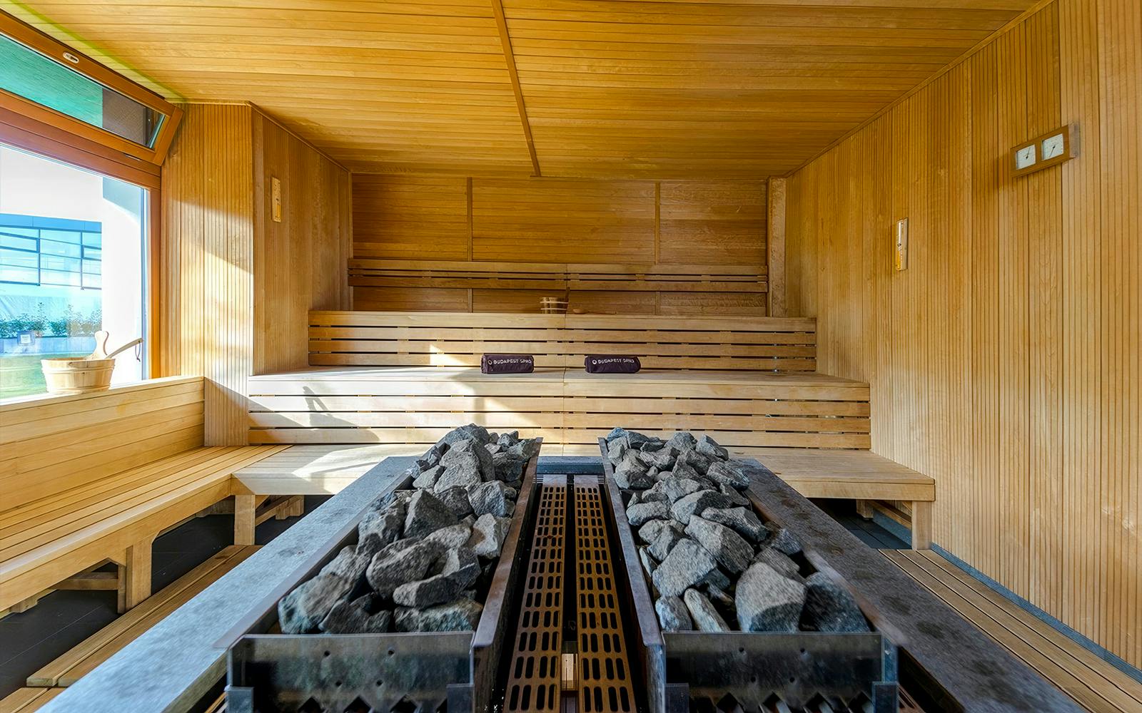Sauna room with wooden benches and hot stones at Paskal Thermal Bath, Budapest.