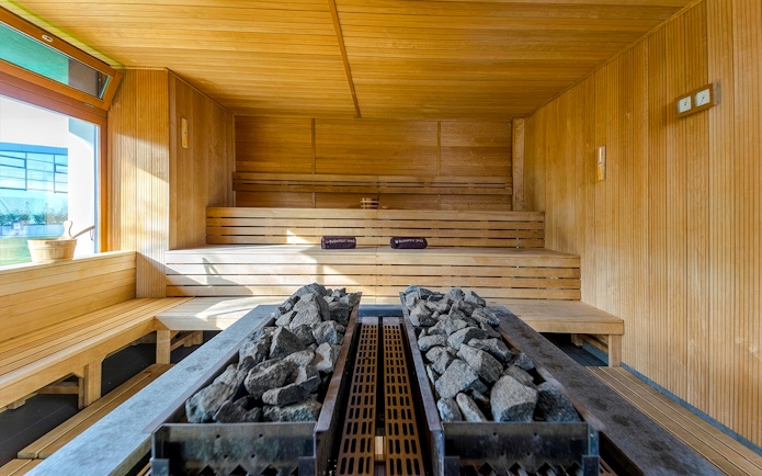 Sauna room with wooden benches and hot stones at Paskal Thermal Bath, Budapest.