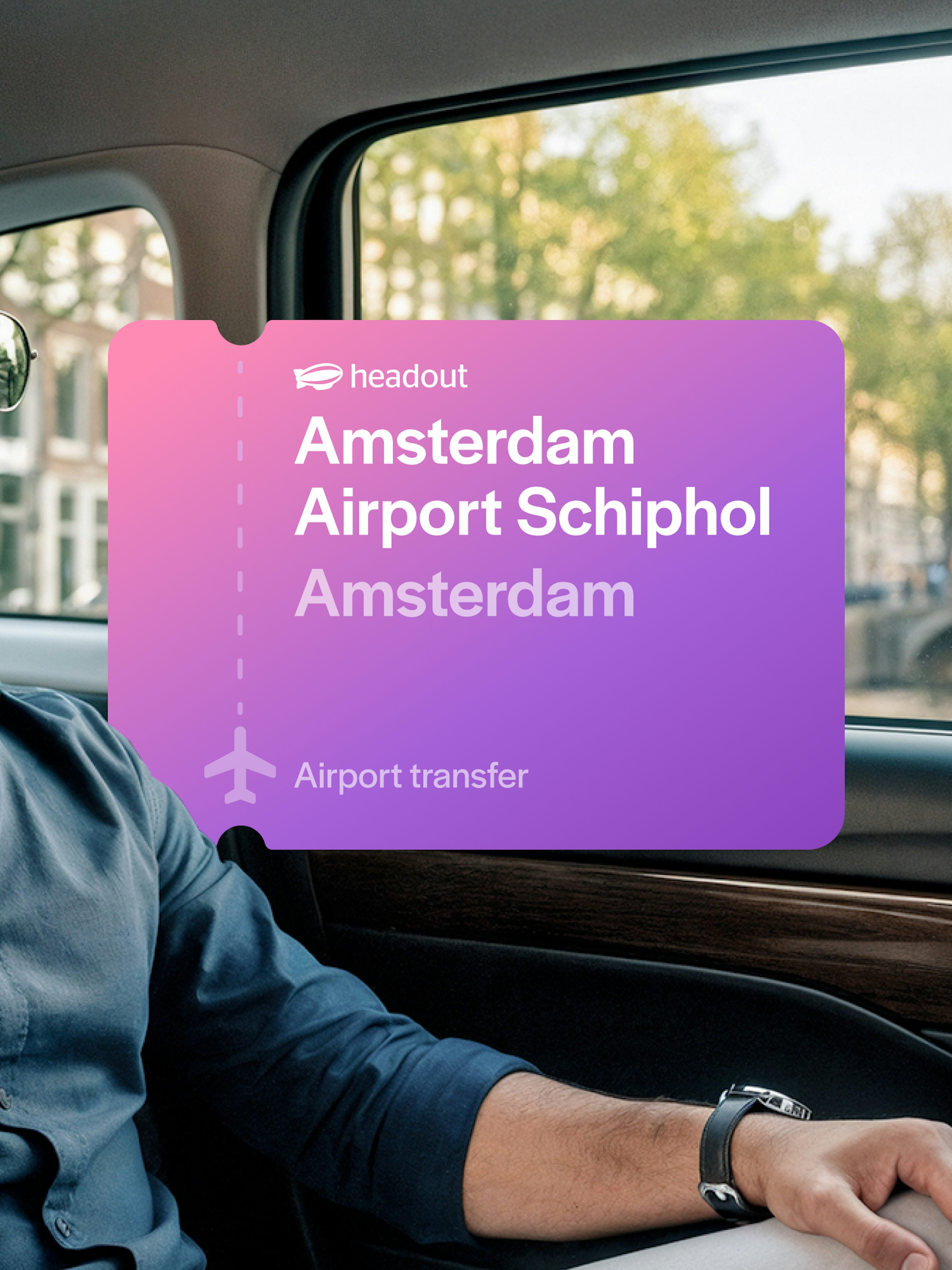 Man in car during Amsterdam airport transfer with canal view.