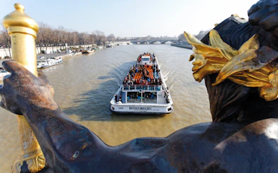 Bateaux Mouches boat cruising on the Seine River in Paris with passengers enjoying live music.