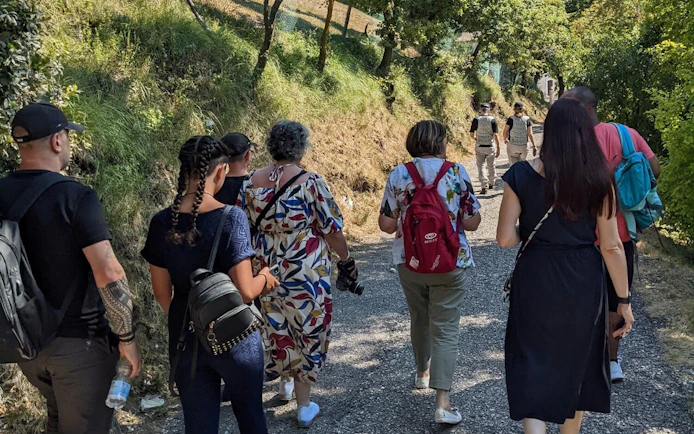Tour group walking on a scenic path near Sirmione, Italy.
