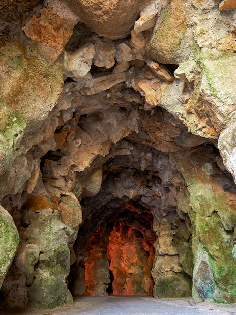 Cave interior with rocky walls at Quinta da Regaleira gardens in Lisbon.