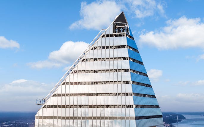 Climbers ascending the edge of a skyscraper during a City Climb Experience.