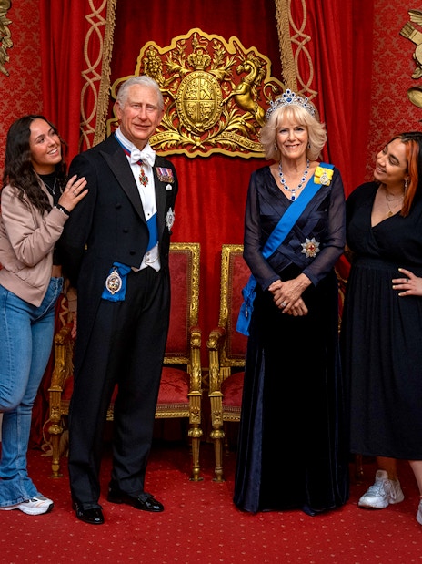 Tourists posing with wax figures of British royalty at Madame Tussauds, London.