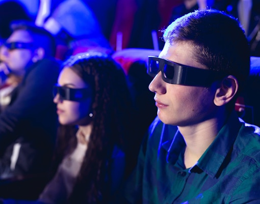 Man wearing glasses watching London Eye 4D cinema experience.