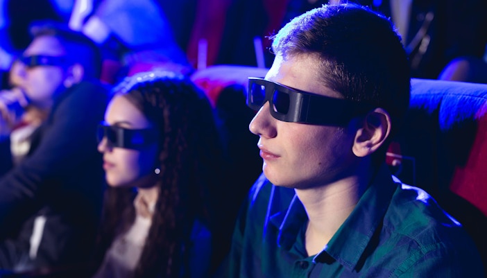 Man wearing 3D glasses at London Eye 4D cinema.