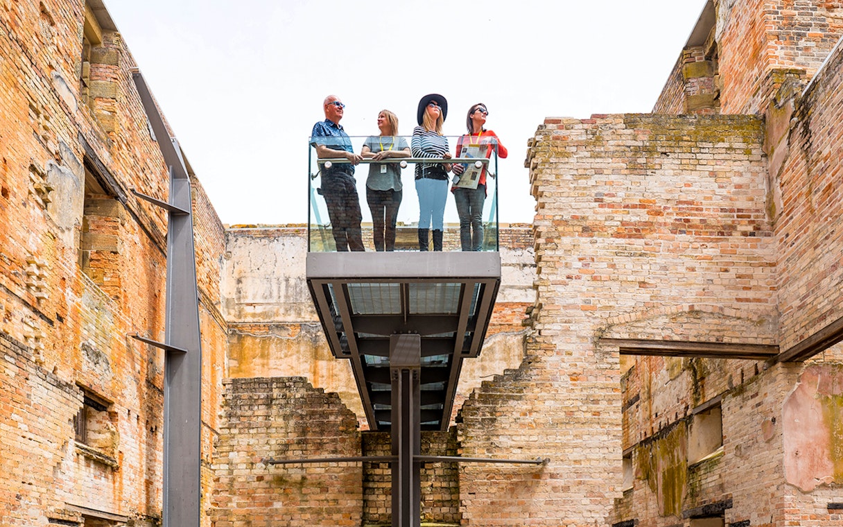 Visitors on a viewing platform at Port Arthur Historic Site Penitentiary, Tasmania.