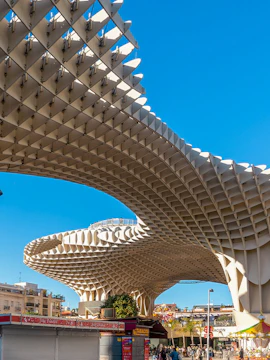 Setas de Sevilla wooden structure in Seville, Spain, with people walking below.
