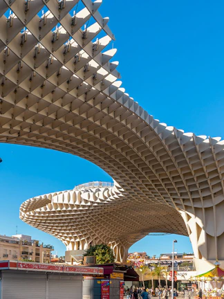 Setas de Sevilla wooden structure in Seville, Spain, with people walking below.