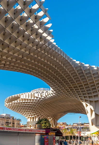 Setas de Sevilla wooden structure in Seville, Spain, with people walking below.