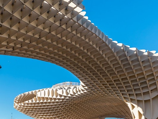 Setas de Sevilla wooden structure in Seville, Spain, with people walking below.