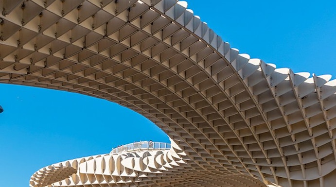 Setas de Sevilla wooden structure in Seville, Spain, with people walking below.