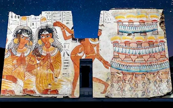Edfu Temple wall illuminated with ancient Egyptian art during sound and light show.