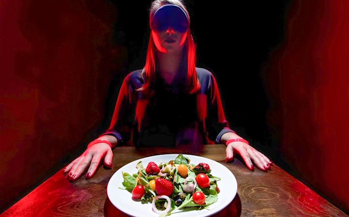 Blindfolded diner with salad at Dining in the Dark, Kuala Lumpur.