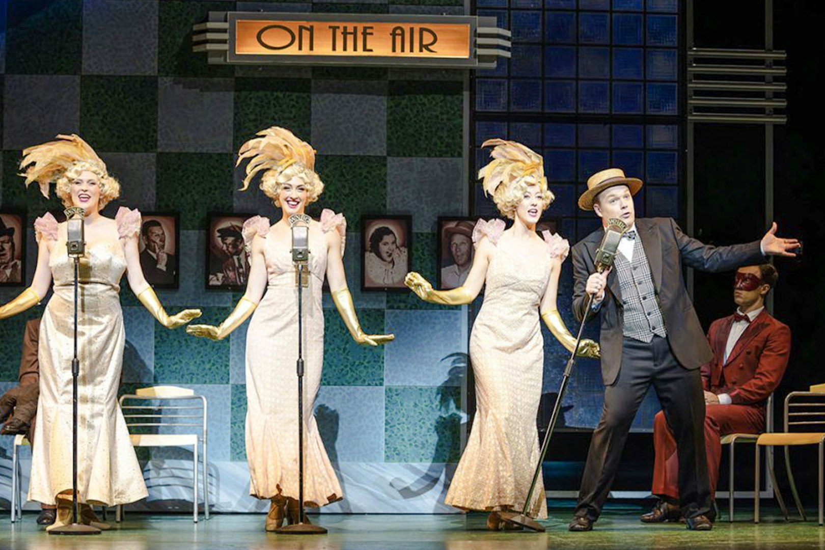 Performers in 1930s attire singing into vintage microphones during an Annie show.