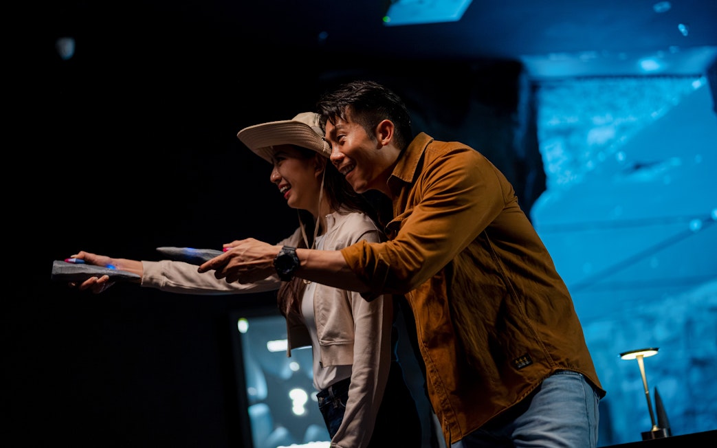 Couple using wearable devices at Enchanted Forest immersive exhibit.