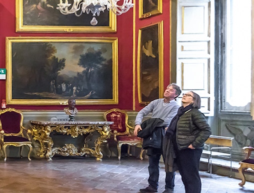 Visitors admiring art in the Doria Pamphilj Gallery, Rome.