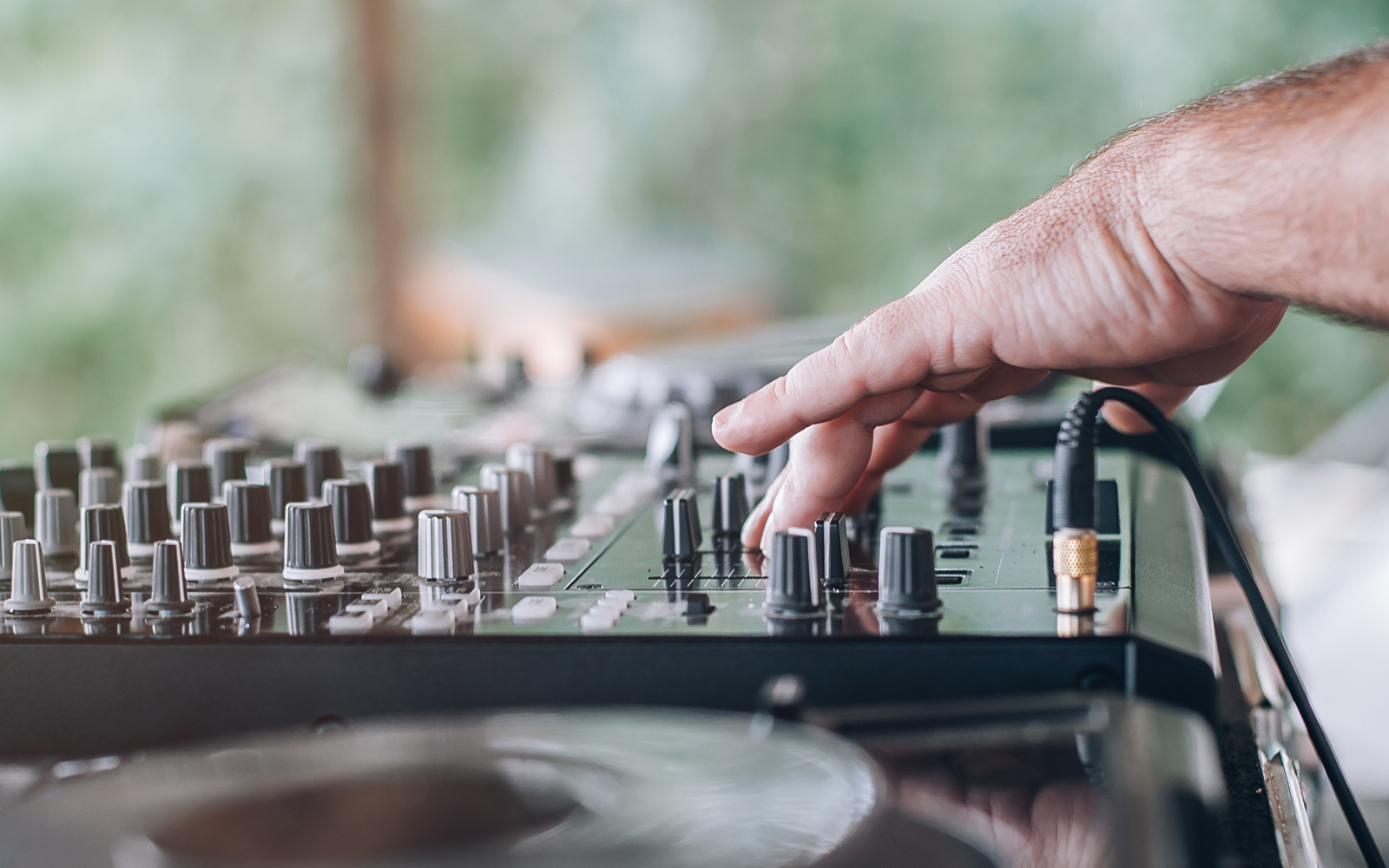 A person handling the DJ System suring day at an island