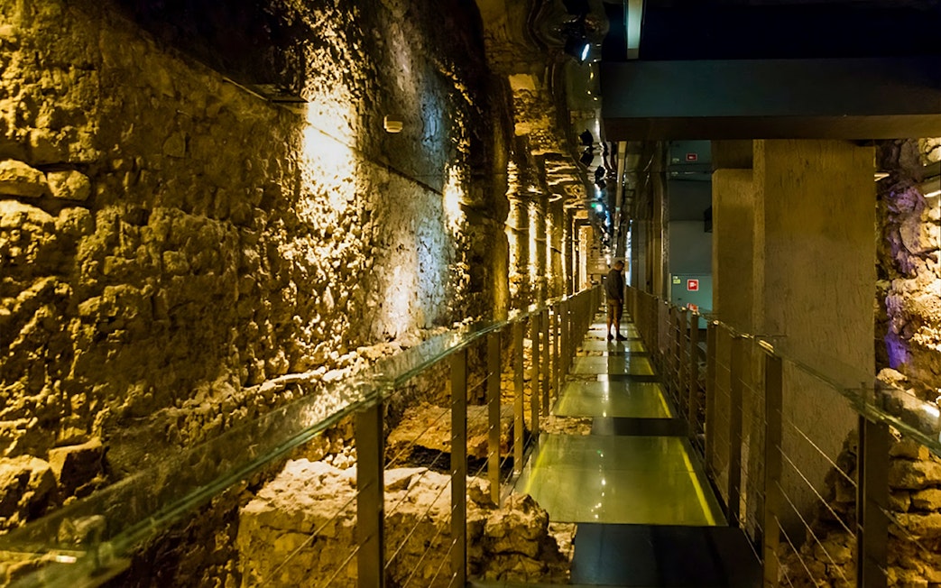 Walkway through ancient stone walls at Rynek Underground Museum, Krakow.