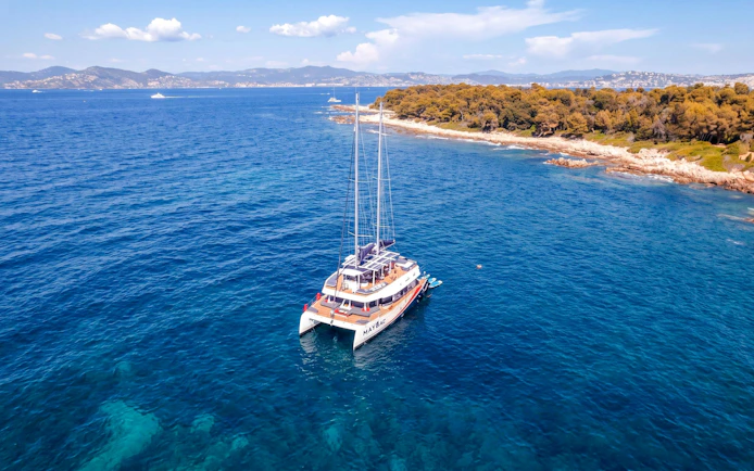 Catamaran cruising near Lérins Island in Marina Bay of Angels.