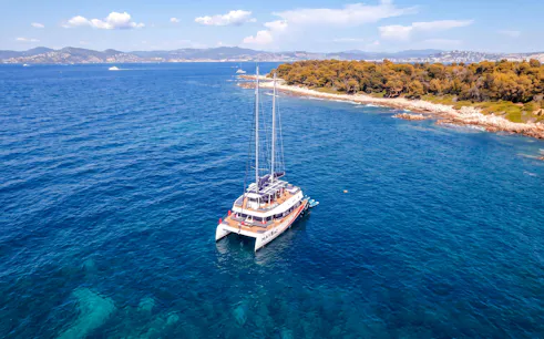 Catamaran cruising near Lérins Island in Marina Bay of Angels.