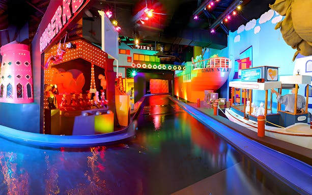 Ginger Factory indoor boat ride with colorful lights and themed displays, part of Play All Day Bundle.