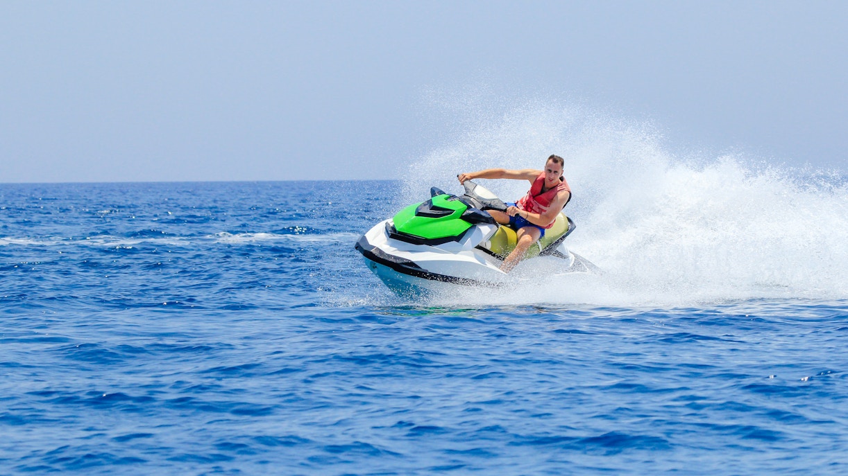 Man riding jet ski on open water in Dubai.