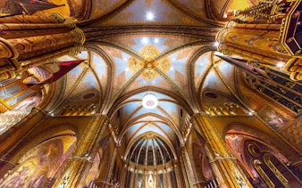Ceiling of Matthias Church in Budapest with intricate Roman Catholic designs.