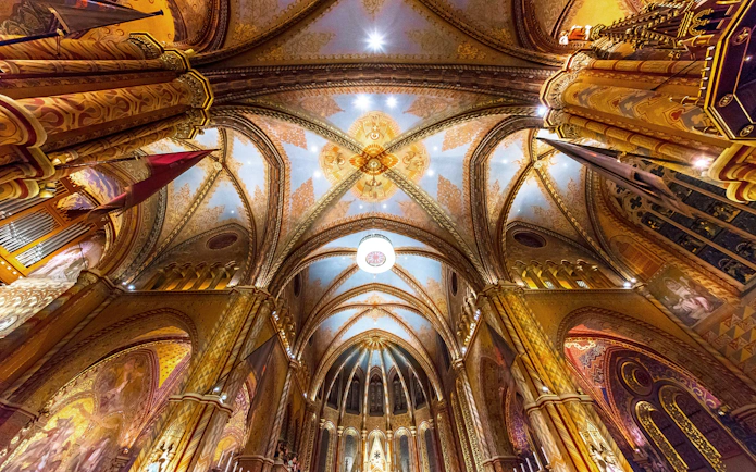 Ceiling of Matthias Church in Budapest with intricate Roman Catholic designs.