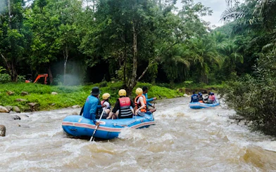 White water rafting adventure in Krabi's lush jungle setting.