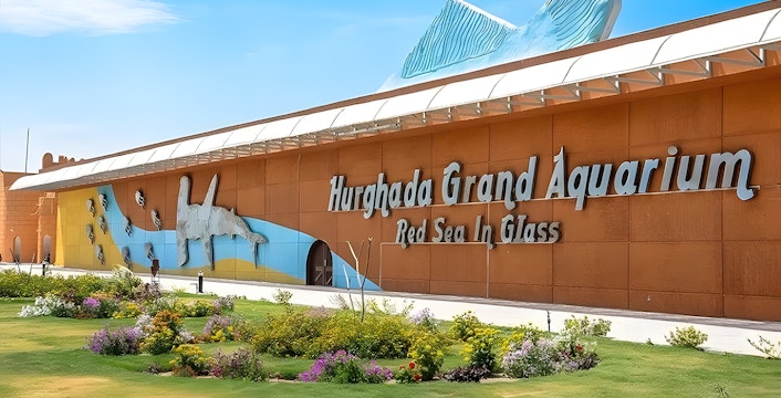 Hurghada Grand Aquarium entrance with colorful mural and garden.