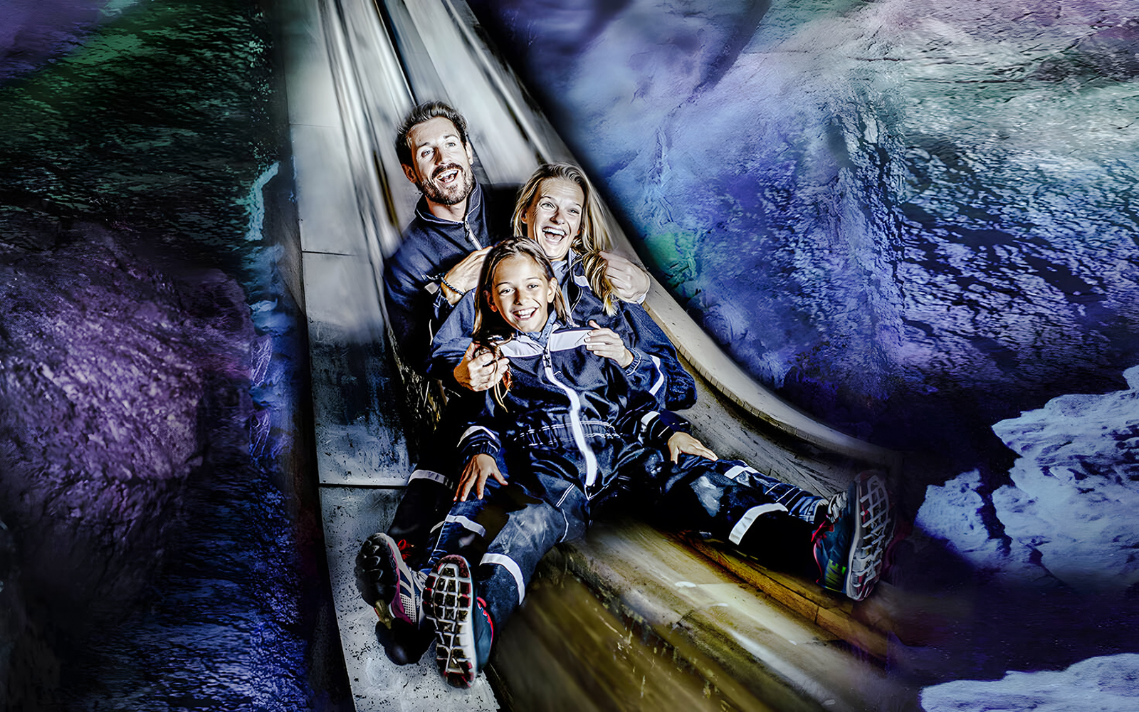 Family sliding inside Berchtesgaden Salt Mine, Bavaria.