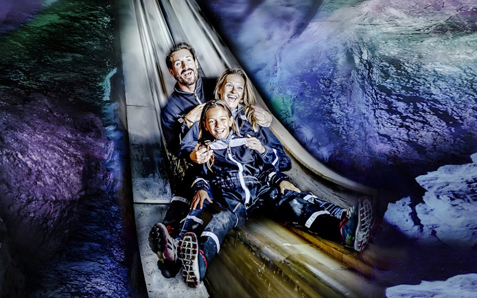 Family sliding inside Berchtesgaden Salt Mine, Bavaria.