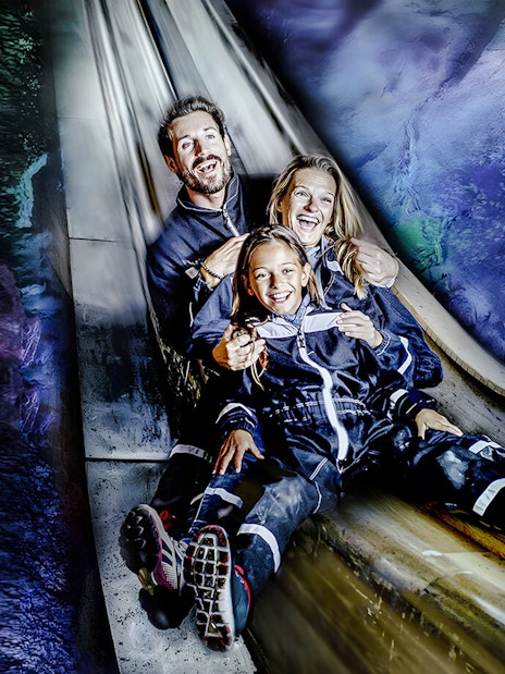 Family sliding inside Berchtesgaden Salt Mine, Bavaria.