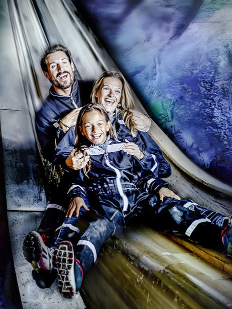 Family sliding inside Berchtesgaden Salt Mine, Bavaria.