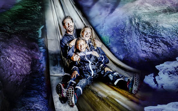 Family sliding inside Berchtesgaden Salt Mine, Bavaria.