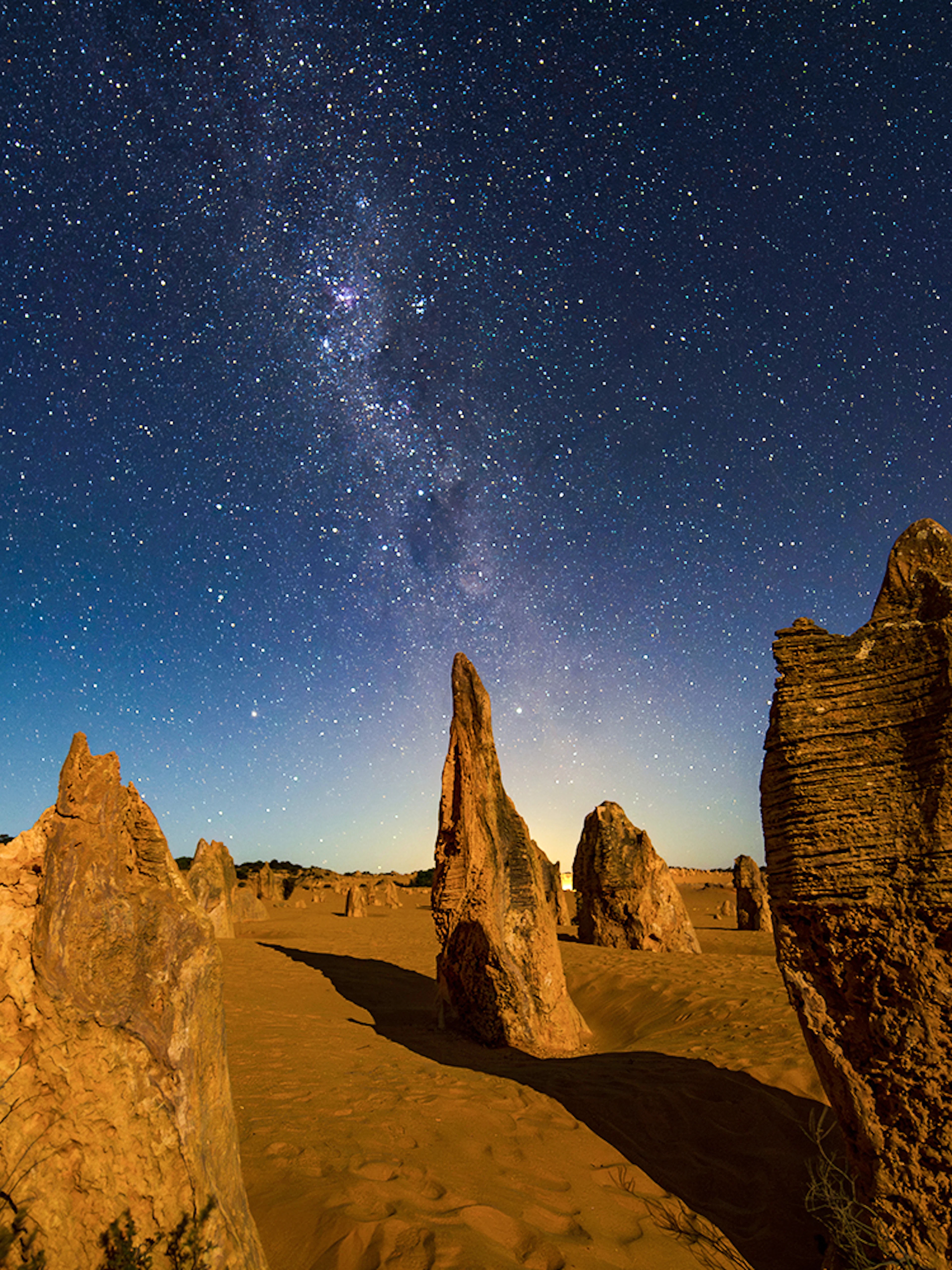 Rock formations under a starry night sky at Pinnacles Desert, Australia.