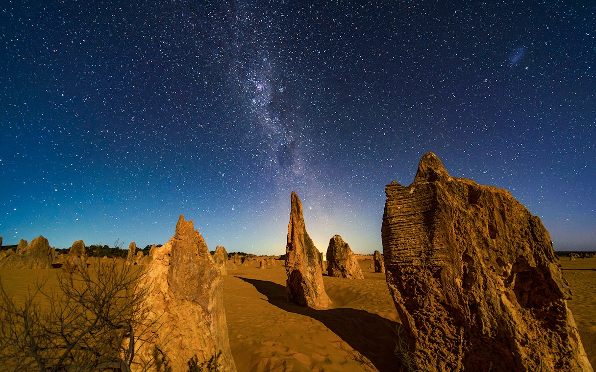 Rock formations under a starry night sky at Pinnacles Desert, Australia.