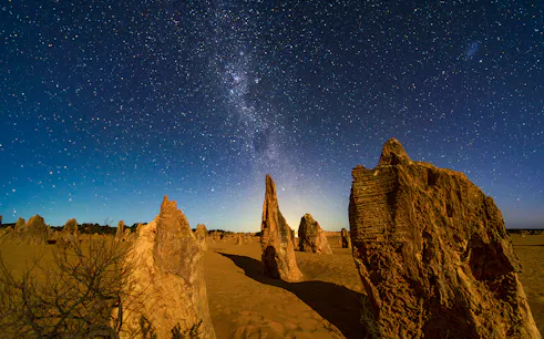 Rock formations under a starry night sky at Pinnacles Desert, Australia.