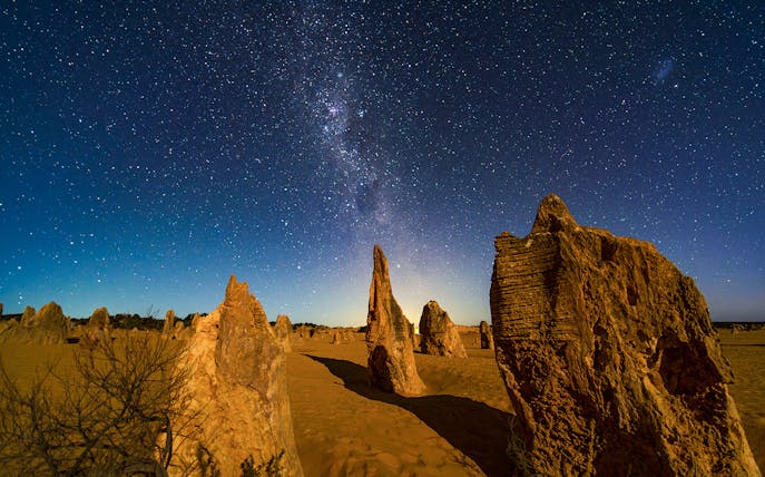 Rock formations under a starry night sky at Pinnacles Desert, Australia.