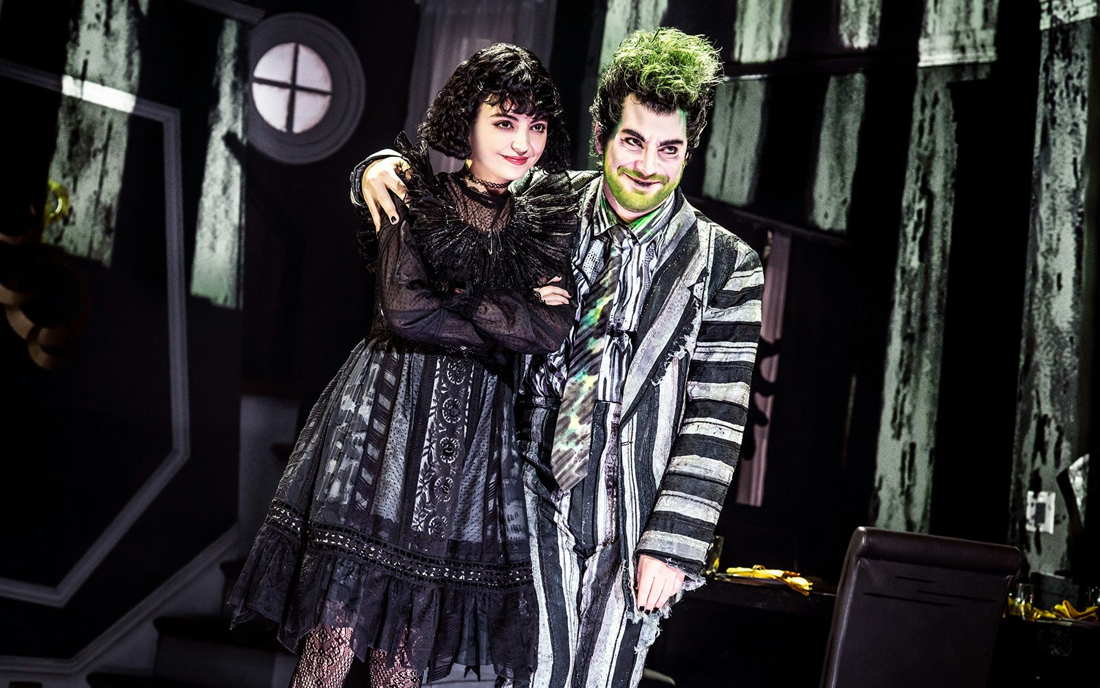 Stage performance of Beetlejuice in West End with two actors in costume.