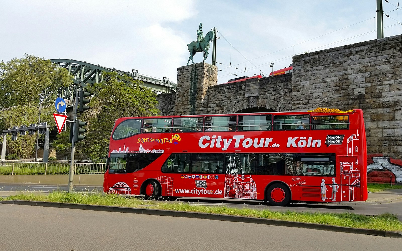 Hop on Hop off City Tour bus in front of Hohenzollern Bridge, Cologne.