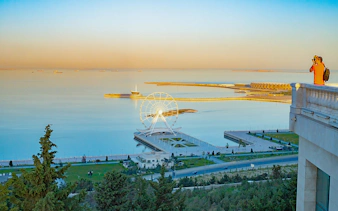 Baku city seaside view from Highland Park with Ferris wheel and promenade.