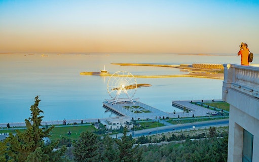 Baku city seaside view from Highland Park with Ferris wheel and promenade.
