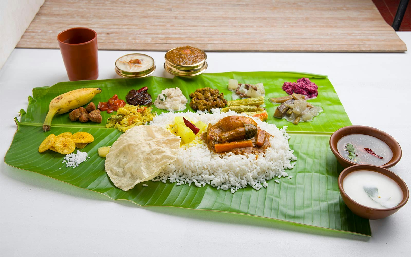 Banana leaf rice meal with assorted curries and side dishes in Kuala Lumpur, Malaysia.