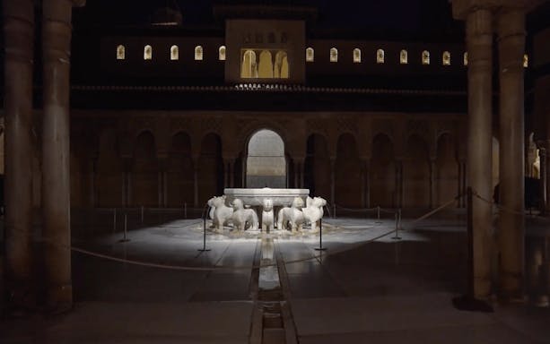 Courtyard of the Lions at Alhambra, Granada, illuminated at night.