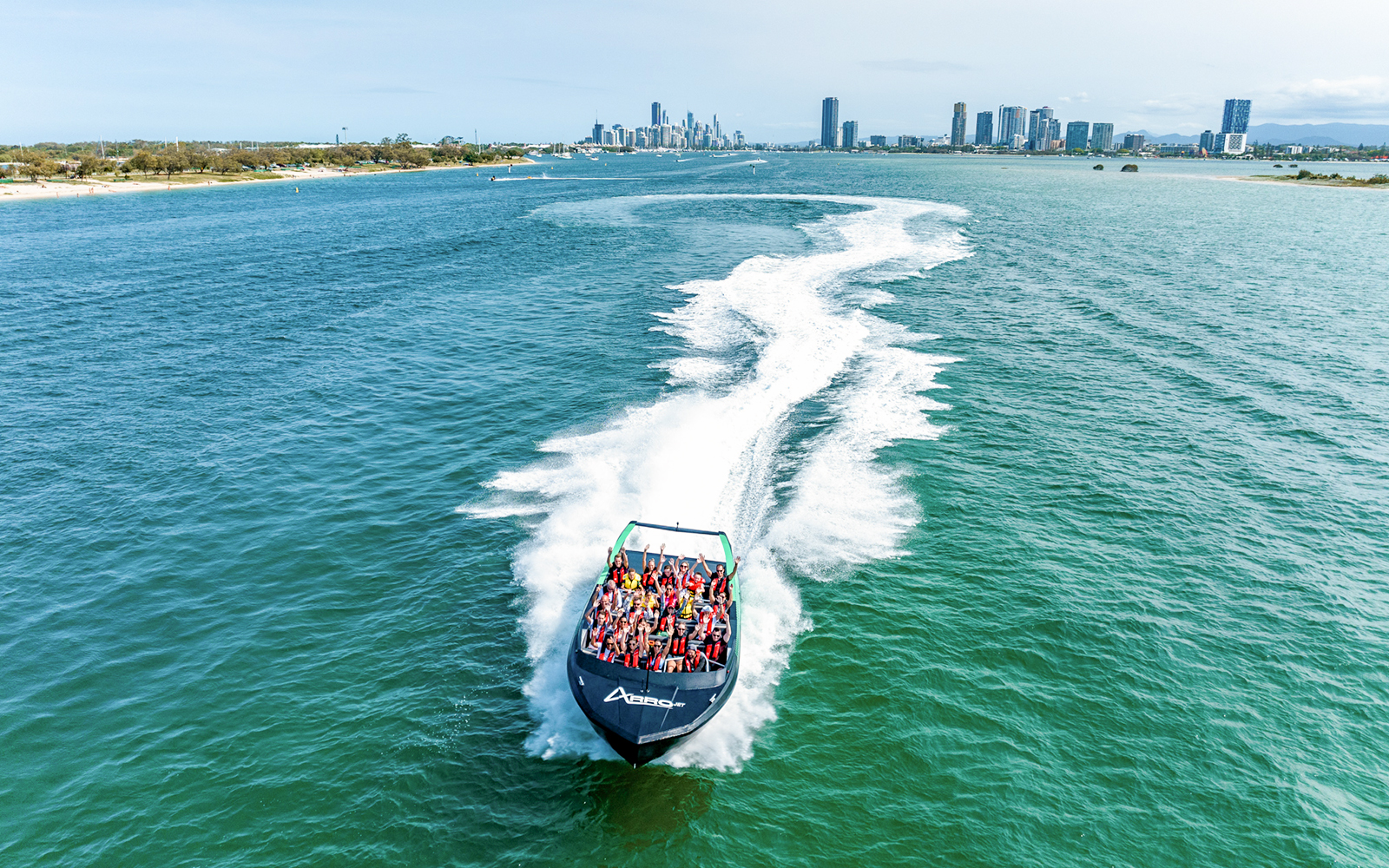Aerial view of Arro Jet Boat creating a wake in Gold Coast waters.